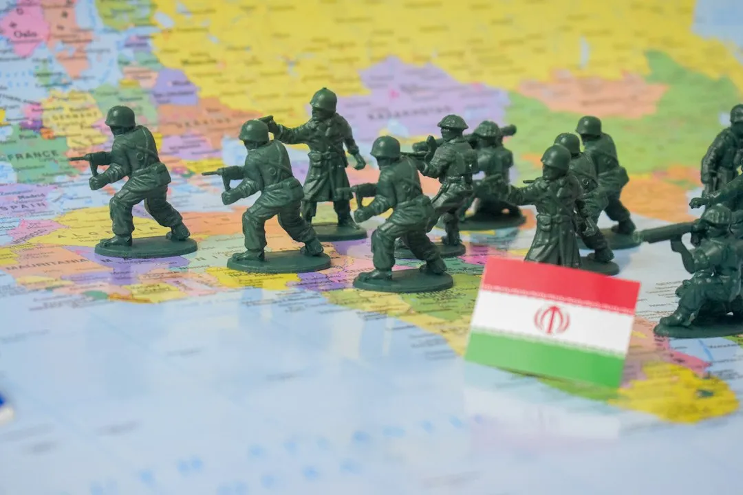 Miniature figures on a map with a flag of Iran depicting war